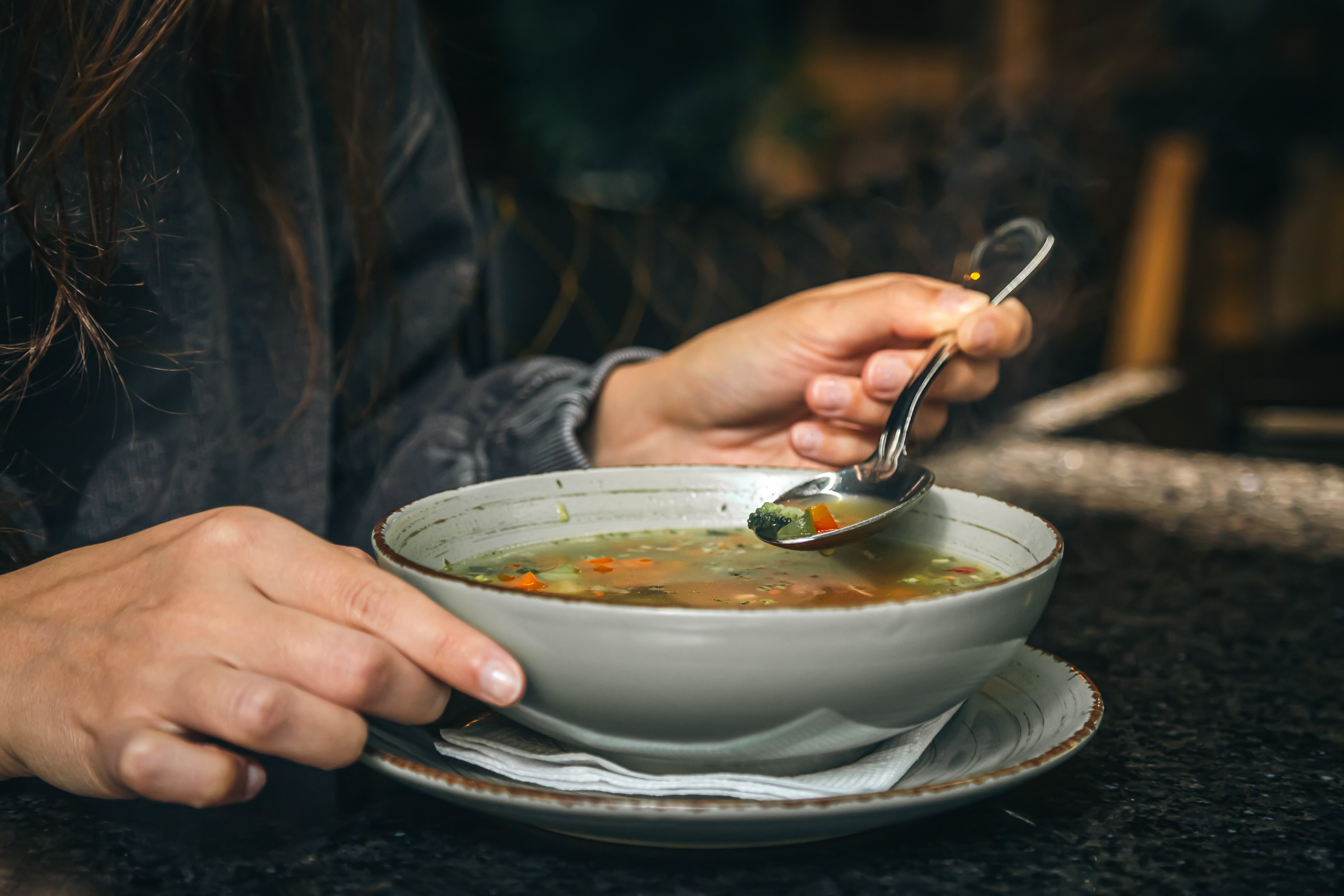 woman-cafe-eats-lowcalorie-vegetable-soup.jpg